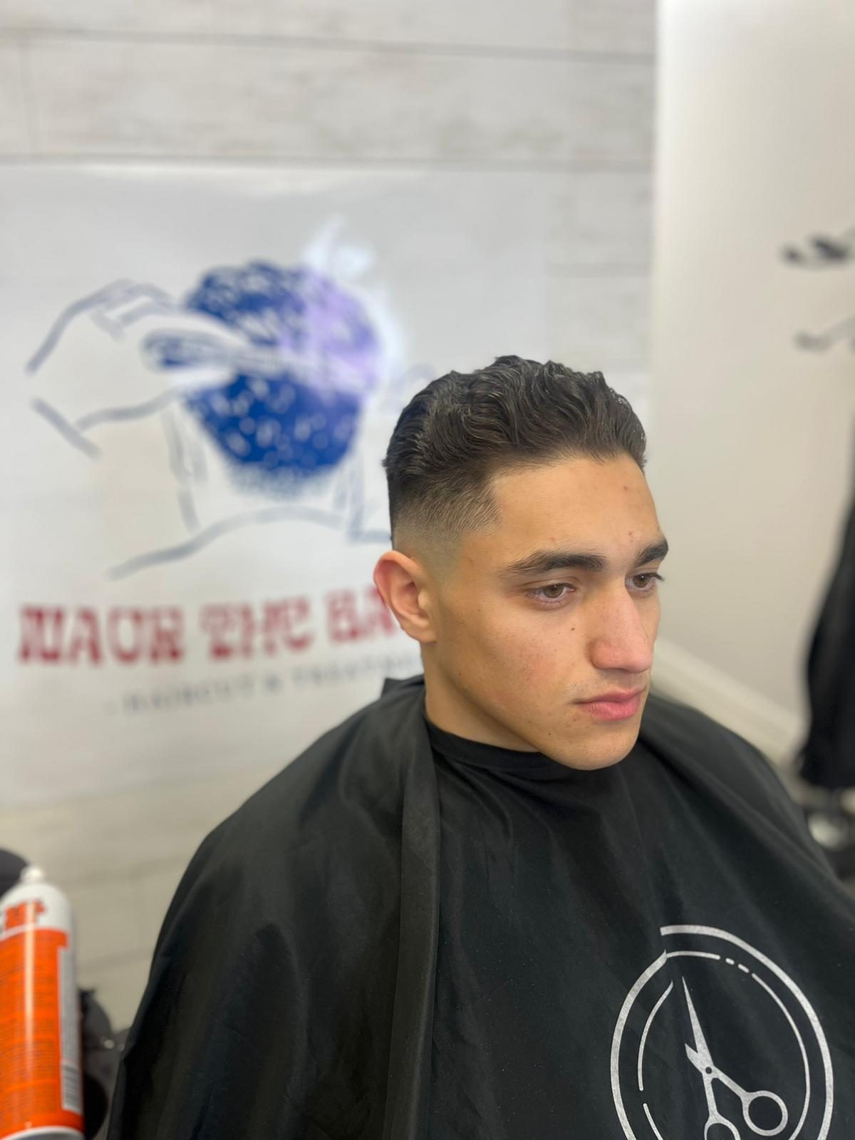 Mid skin fade with textured top, finished at Naor the Barber Studio in Saint-Laurent